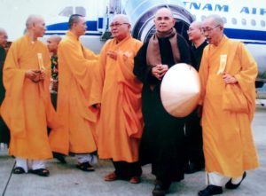 Picture of Hanh and other monks leaving an airplane.